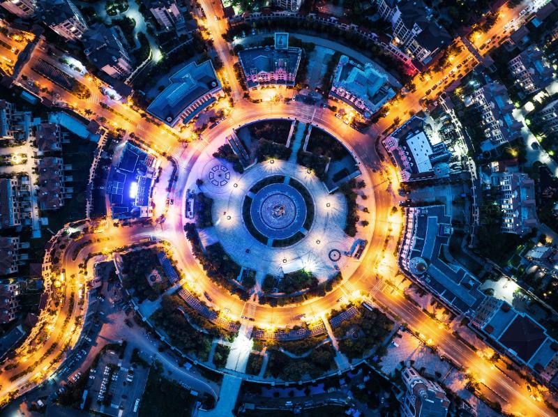 Image of a busy roundabout at night time